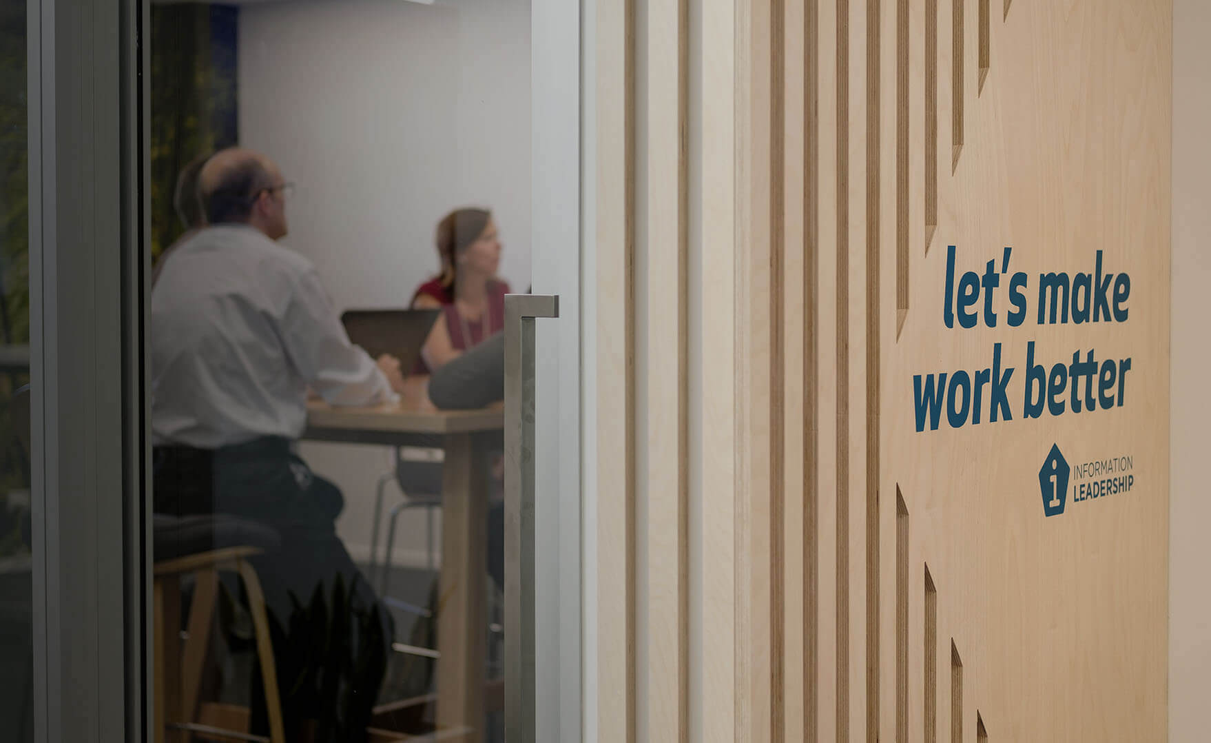 news shadow - A Information Leadership meeting room with text on the door: Let's make work better