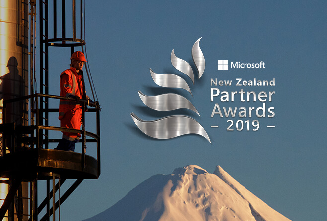 A Todd Energy employee standing in front of Mt Taranaki with the Microsoft New Zealand Partner Awards 2019 Logo overlayed