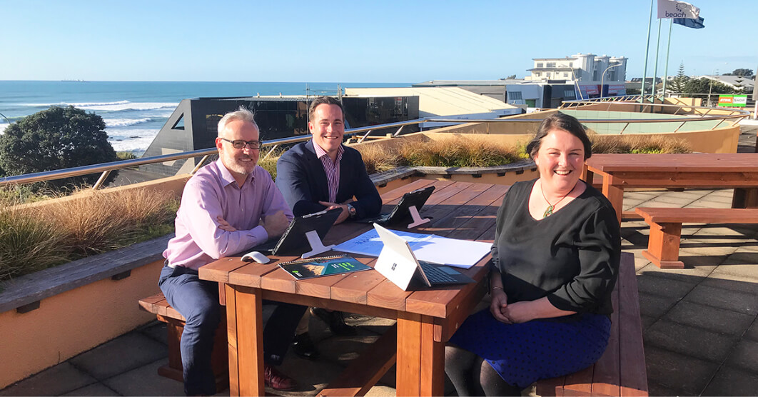 news - Todd Energy sitting with a Office 265 consultant by the beach
